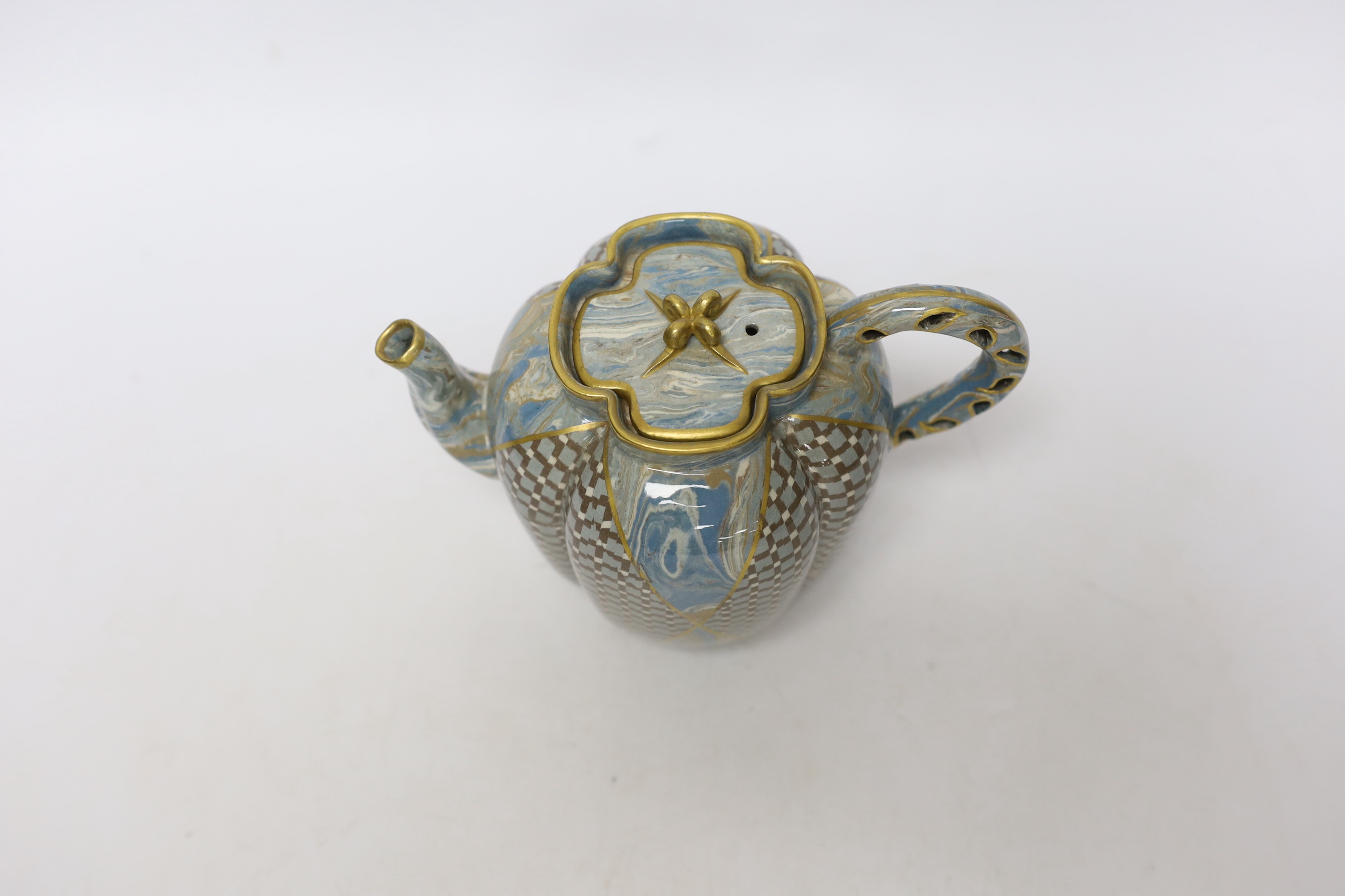 A good Doulton & Rix's patent Marqueterie ware teapot, c.1887, of quatrelobed form with 'teardrop' pierced handle, alternating panels of lattice and marbling, black printed mark and inscribed in black 646B, 16.5cm wide